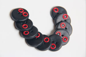 A set of polymer clay buttons with decorative grommets