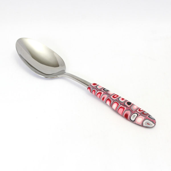Pink, red, white, grey, and black serving spoon