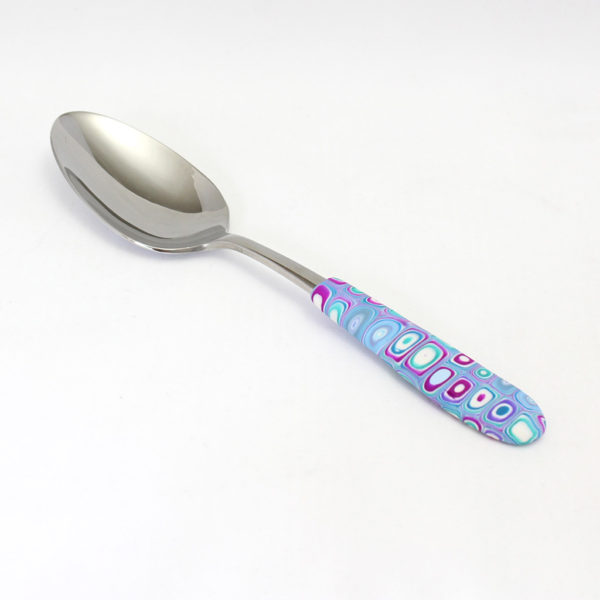 Green, teal, purple, and fuchsia serving spoon
