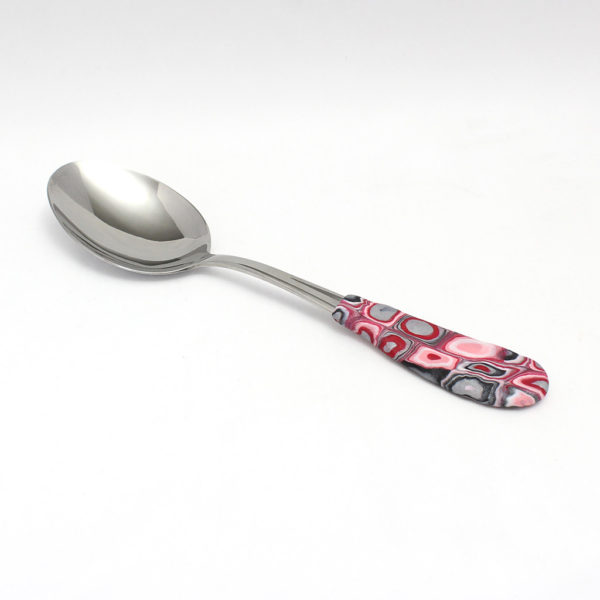 Pink, red, white, grey, and black blobs serving spoon